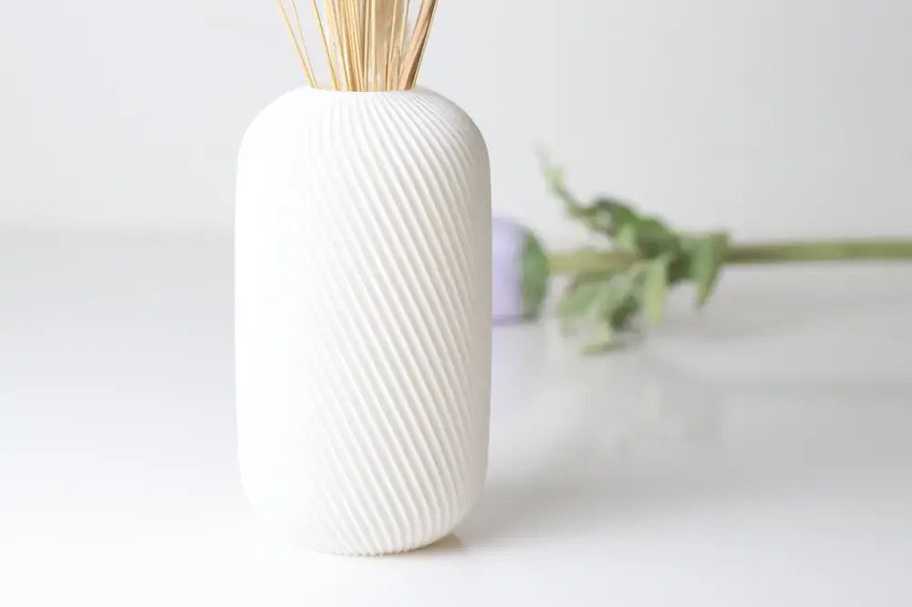 Elegant white vase with textured design, perfect for modern home decor and flower arrangements.